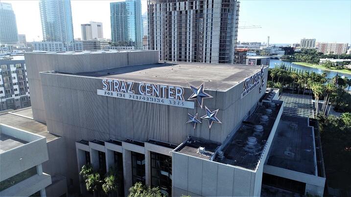 A view of the Straz Center for the Performing Arts with a city skyline in the background